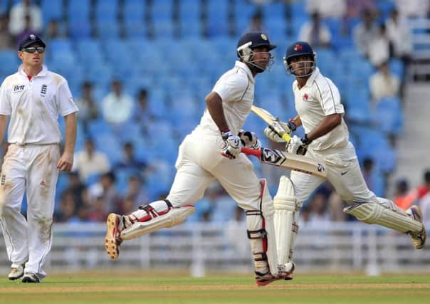 Mumbai A.'s batsmen Cheteshwar Pujara, second left, and Hiken Shah, left, run between the wickets as England's Ian Bell watches the play during their second warm-up match in Mumbai, India, Sunday, Nov. 4, 2012. (AP Photo/Rajanish Kakade)