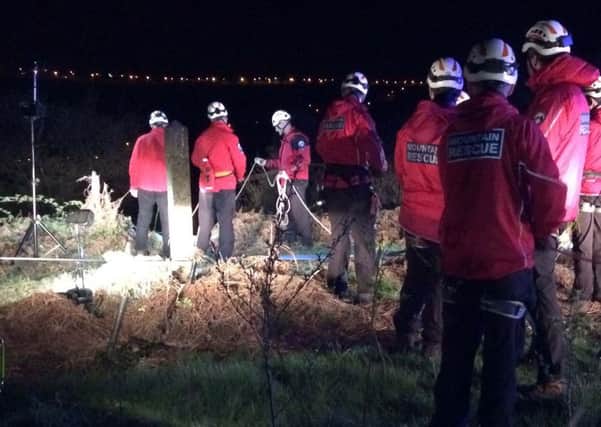 Calder Valley Search and Rescue Team members rescue a woman in Ovenden