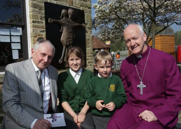 Rev Nick Baines and Graham Alcock with pupils Millie Kershaw and James Crowther at the unvieling of the new Cross at Lightcliffe CE Primary School.
