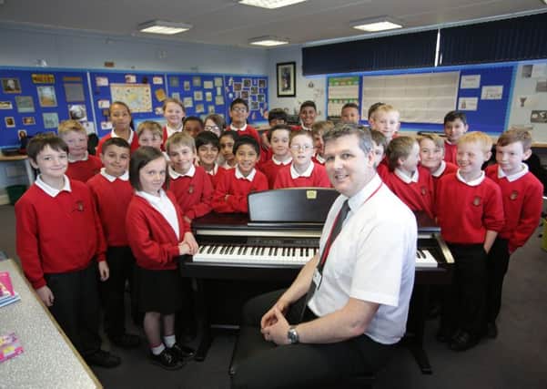 Ofsted at Longroyde Junior School, Longroyde Road, Brighouse. Head teacher Robert Fox with music students.