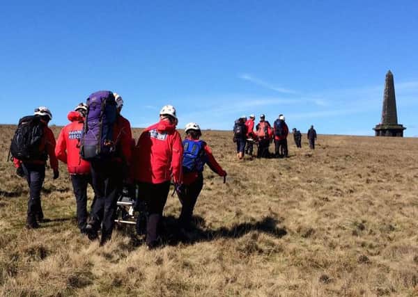 Teenage brothers Andrew and Nathan Greenwood being transported across moorland in their Aim Higher Stoodley Pike challenge