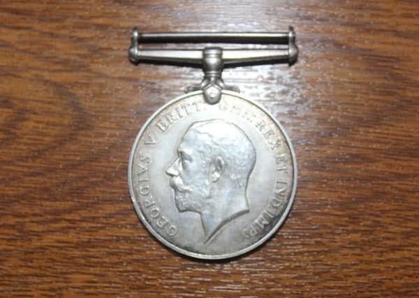 A World War One service medal similar to the one stolen in Todmorden  between Thursday, April 16, and Sunday,  April 19. The medal stolen in Todmorden did not have a ribbon but was engraved with "H.Mitchell" and is silver with a bar attached.