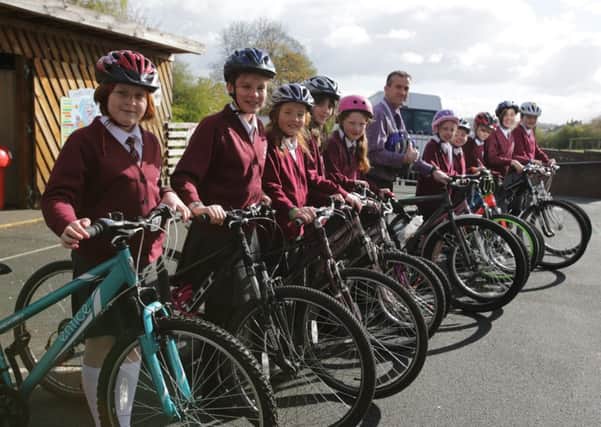 Head teacher Graeme Genty and pupils at St Chad's Primary School in Hove Edge on their bikes
