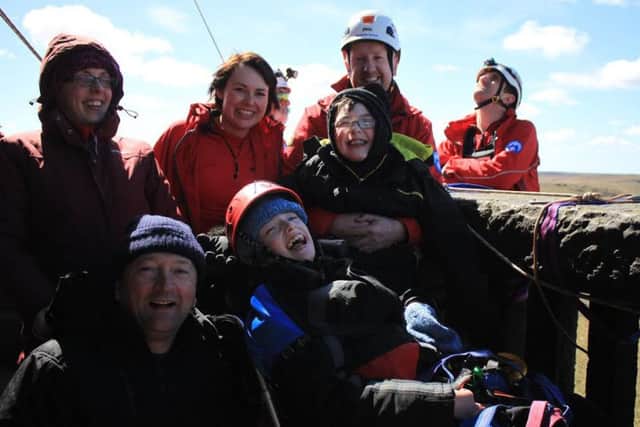 Nathan, centre, with brother Andrew, parents Joanne and Eldred, left, and volunteers from Calder Valley Search and Rescue Team at Stoodley Pike