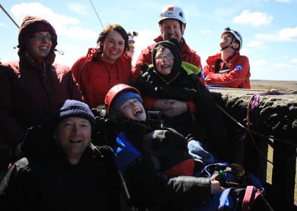 Nathan, centre, with brother Andrew, parents Joanne and Eldred, left, and volunteers from Calder Valley Search and Rescue Team at Stoodley Pike