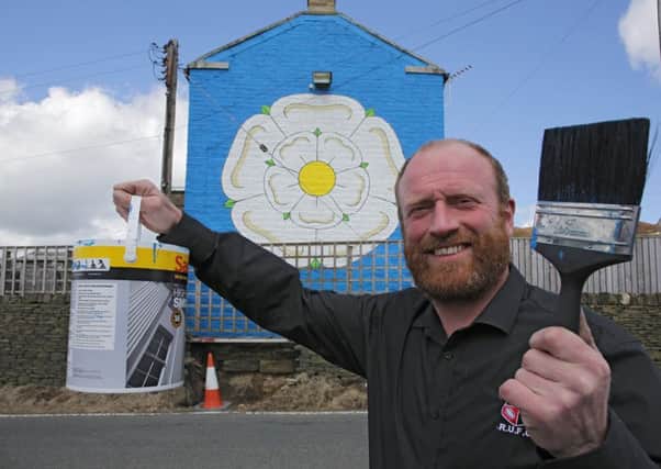 Richard Palliser with giant Yorkshire Rose on his house.