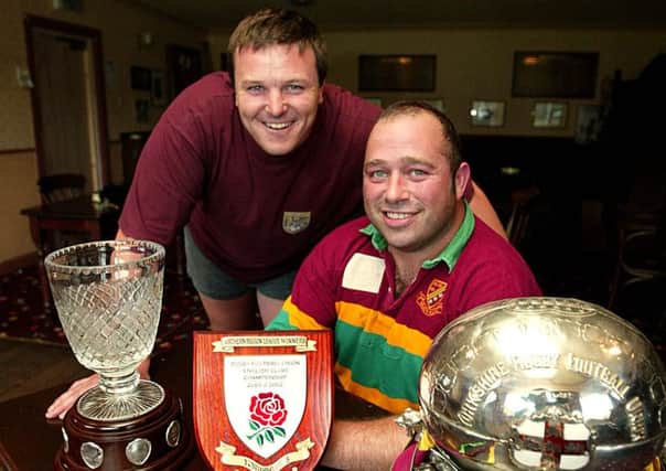 Heath 9.7.2002 Ian D Swift 2 pic's sport. The new captain of Heath rugby union club, Tom Garnett, left, is pictured with the retiring captain, Dave Harrison, right. They are pictured showing off the trophies they won is