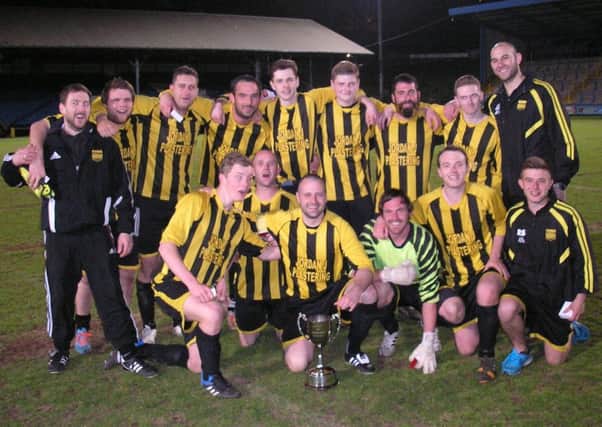 Midgley United Reserves celebrate their Invitation Cup final win at the Shay