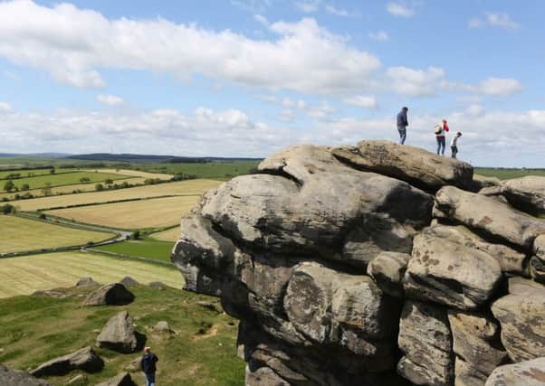 Picture Shows people enjoying the warm weather and sunshine high up on Almscliffe Crag in North Yorkshire. Ian Hinchliffe / Rossparry.co.uk