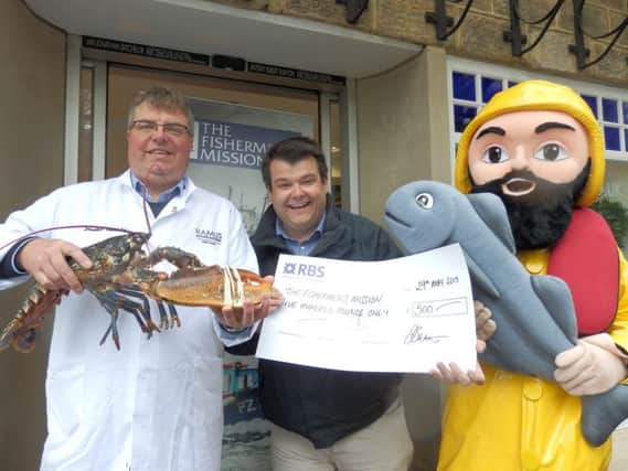 Jonathan Batchelor, managing director of Ramus Seafoods, presented a cheque for £500 to Chris Hirst, corporate fundraising manager for the Fishermens Mission, and the charity's mascot, Albert The Fisherman. The money was raised through sales of Ramus' cookbook, Forty. (S)