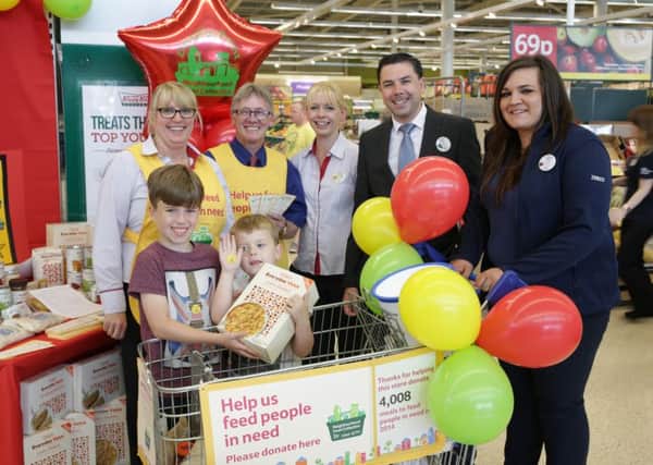 Tesco staff at Brighouse with their new neighbourhood food collection. Michelle Bowman, John Foley, Sharon Kilner, Chris O'Brien and Beth Smith  with customers Joshua and Oliver Shields aged 10 and six.