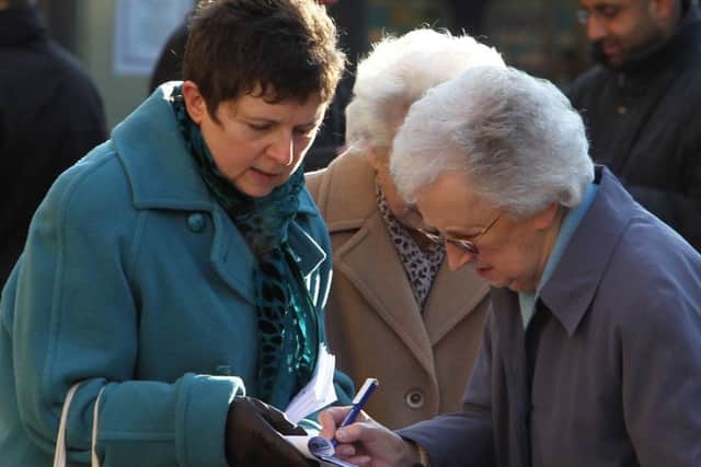 Trade unions collecting names on petition opposing spending cuts in Halifax Town Centre - outside Calderdale Council's Northgate House.
Pictured is unions spokeswoman Sue McMahon - left.