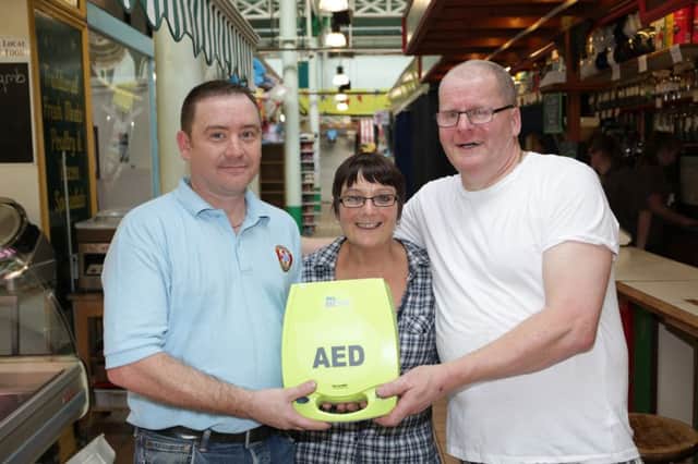 Unveiling of a new defibrillator at Todmorden Market. Dean Mills, Tizzy Robertson and Tony Thomas.