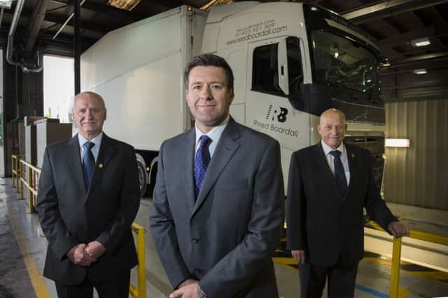Howard Gill (centre), managing director of Reed Boardall Transport, with Denzil Cooke, transport compliance manager for Reed Boardall, and Frank Appleton, fleet manager for Boroughbridge Motors. (S)