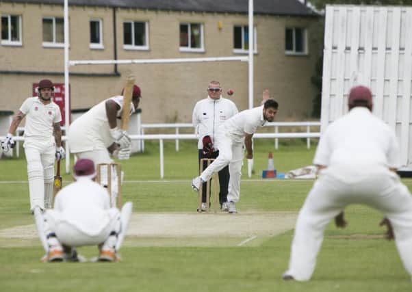 Cricket - Brighouse v Hartshead Moor. Nadim Hussain bowls for Brighouse.
