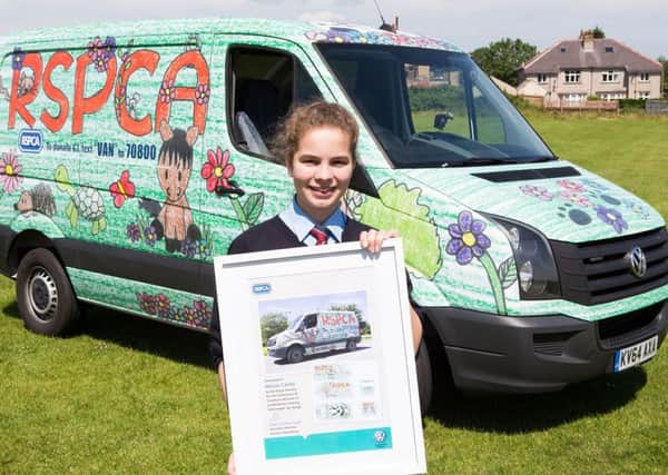 Maisie Carter, with the VW commercial van  covered in her winning design, for the RSPCA