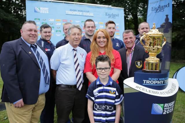 Members of Halifax Ruby Union Club with the Rugby World Cup.
