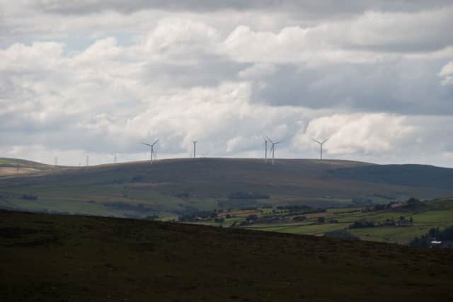 The huge new wind-turbines on hills behind Todmorden. ruining scenic views of Stoodley Pike.