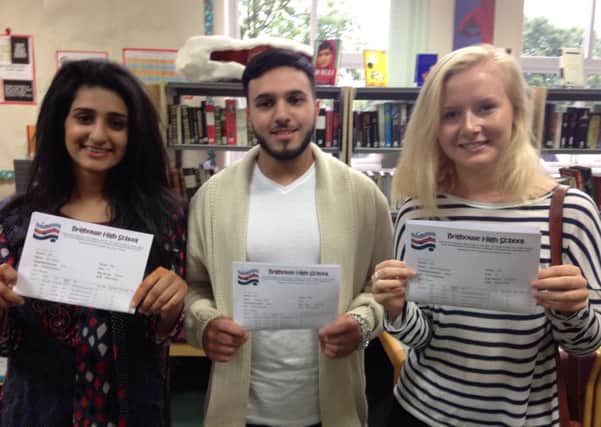 Ikra Akram, Ahtsham Tahir and Abbey Booth with their A-Level results at Brighouse High