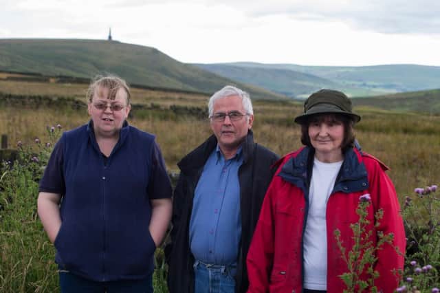 Erringden Parish Councillors, Fiona Gibbon, Alan Wright and Fay Blackburn, disappointed with the huge new wind-turbines on hills behind Todmorden. ruining scenic views of Stoodley Pike.