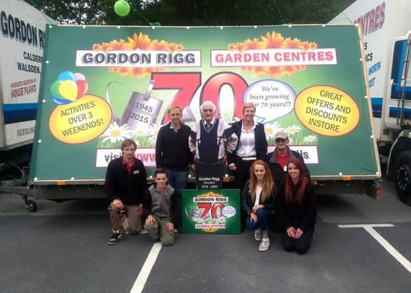 Celebrating the 70th anniversary of the Gordon Rigg garden centre, Walsden - and complete with a life-size standee of late founder Gordon, centre, are, from the left, Anthony Rigg, Daniel Rigg, Peter Rigg, Pauline Rigg, Olivia Rigg, Jon Roberts and Fiona Roberts.