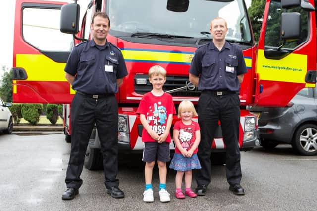Family fun day for charity, at Rastrick Bowling Club, Toothill Bank, Brighouse. Pictured is crew commander Tony Rostron, Hary and Emma Shaw, and fire fighter Bob Peacock