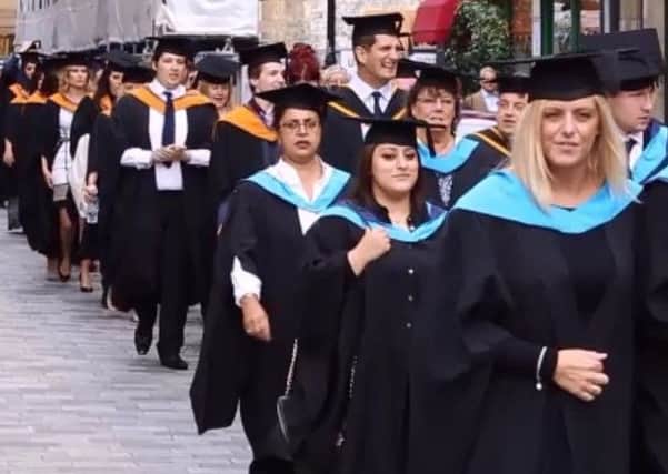 Calderdale College Higher Education Centre students parade through Halifax town centre.