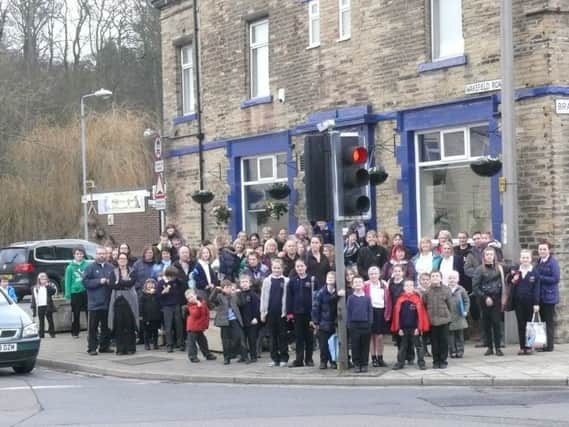 Residents gather at the crossroads in the heart of Bailiff Bridge to campaign for a new pelican crossing claiming pedestrians are dicing with death when trying to cross the roads