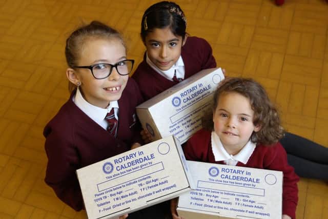 Alice Coe ten, Summer Brearley eight and Katy Kirk aged four with with their Rotary Club shoebox's at St Chad's School, Hove Edge.