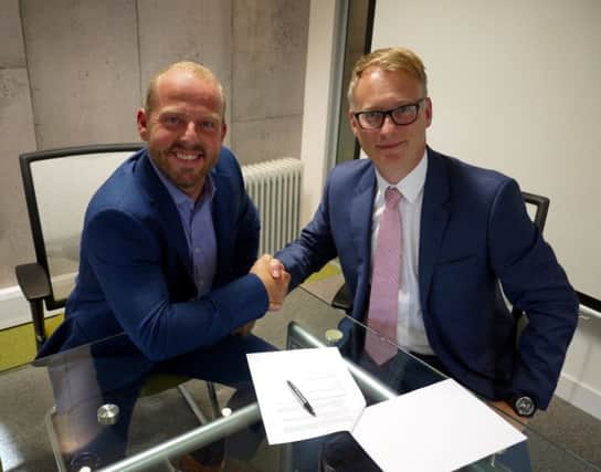 Neil Richards-Smith of NCI and Brian Spinks, head of new busienss at Aviva, celebrate signing the deal. (S)