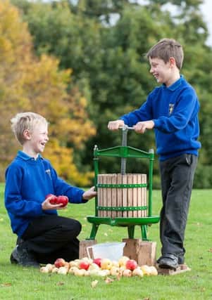 Lawrence Whitmarsh (8)  and Josh Snowdon (9) from Pickhill CE Primary School juicing apples at the G Yorkshire Showground.