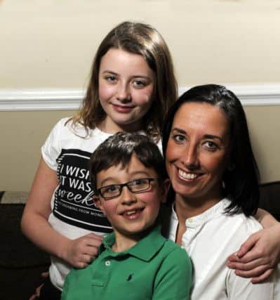 Thomas, 7,  and Beth Hale, 11, and their mother Liz from Halifax.  Thomas had Retinoblastoma when he was a baby and they have been recognised by the Childhood Eye Cancer Trust which recognises the bravery of children who have been touched by eye cancer and are now  'CHECT Champions'.   24 November 2015.  Picture Bruce Rollinson