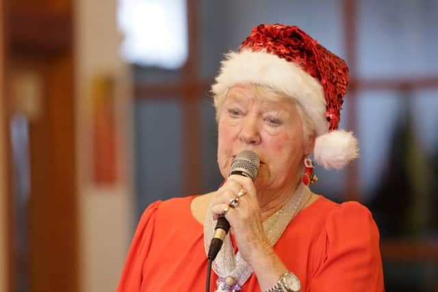 Sing along with John Christmas party at St Paul's Methodist Church, Sowerby Bridge. Margaret Wilson sings a Christmas carol.