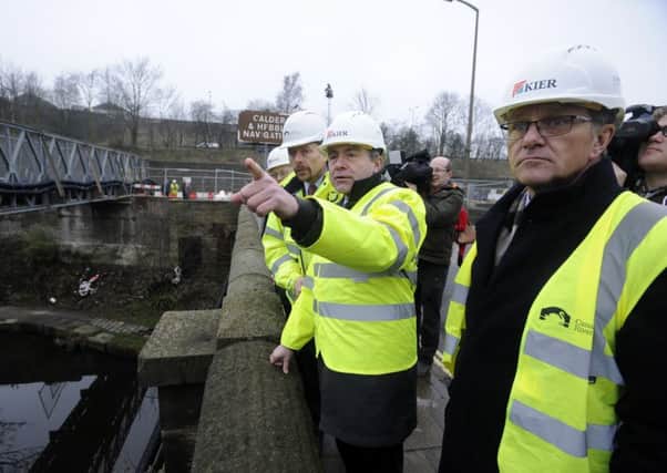 Yorkshire flood envoy Robert Goodwill MP and Calder Valley MP Craig Whittaker (right) survey damage to Elland Bridge caused by the Boxing Day floods.  Picture Bruce Rollinson