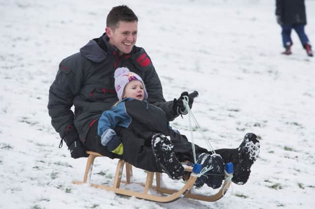 Snow in Halifax. Sledging at Shibden Park. Jonathan Edgar with daughter Lucy, four.