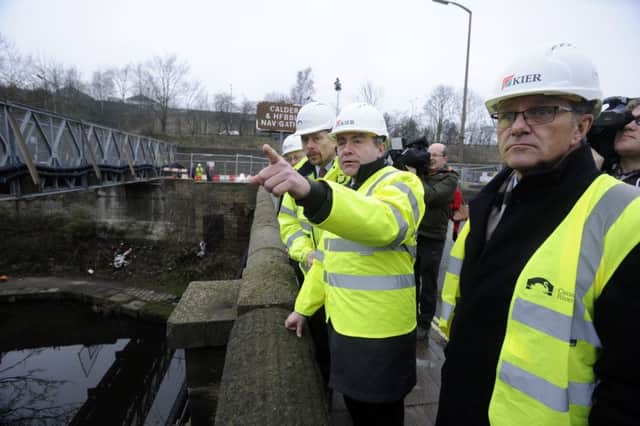 Yorkshire flood envoy Robert Goodwill MP and Calder Valley MP Craig Whittaker (right) survey damage to Elland Bridge caused by the Boxing Day floods.  18 january 2016.  Picture Bruce Rollinson