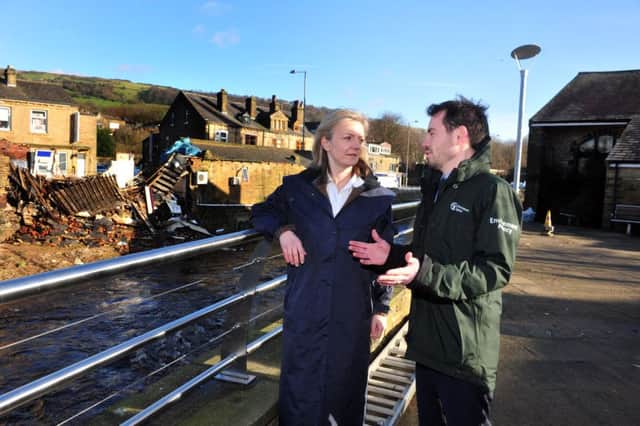 Envionment Secretary Elizabeth Truss  with Adrian Gill, Area Flood Risk manager for the Enviroment Agency, in Mytholmroyd
