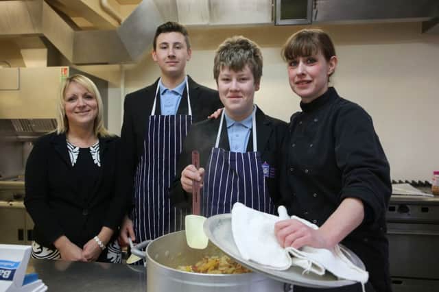 William Henry Smith School, Rastrick achieve the Food for Life gold award. prparing lucnh in the S=school kitchen are Caroline Booth, Kyle Robertshaw 14, Jimmy Wilkinson 15 and Lindsey Marks.