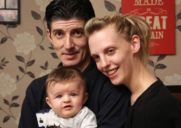 Amy Pearson and John Davies with their four month old son Jack who suffers from flat head syndrome