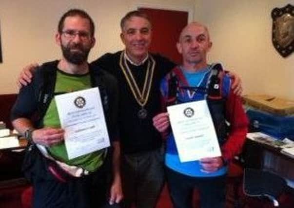 David Macdonald, Todmorden Rotary Club president, presents certificates for the Boundary Walk - runners Ben Crowther, left, and Dwane Dixon, right, were first home