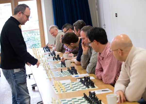 British Grandmaster, Danny Gormally, playing 21 matches of simultaneous chess, in aid of the floods. Town Hall, Hebden Bridge