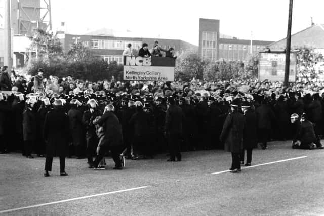 Police hold back pickets outside Kellinley Colliery.