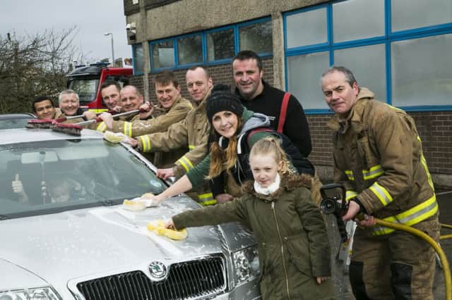 Car wash fundraiser at Halifax Fire Station. From the left, Fraser Coley, Dom Furby, Andy Wood, Steve Naylor, Andy Valentine, Sam Moxen, Holly Senior, Paul Daly, Niamh Furby, nine, and Andy Davenport.