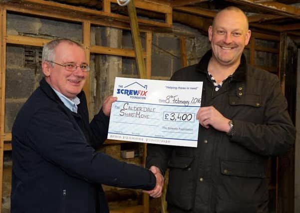 Screwfix Foundation presents a cheque to Calderdale SmartMove Manager of ScrewFix Halifax Jim Connell with Craig George Fundraising manager for Calderdale SmartMove