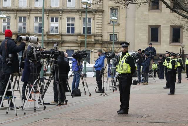 Media and police officers await the arrival of former England footballer Adam Johnson at Bradford Crown Court.