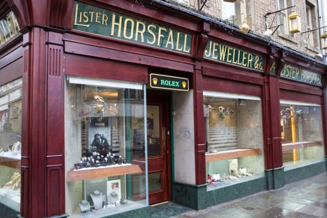 Workmen remove broken display cases after a robbery at Lister Horsfall Jeweller, Halifax