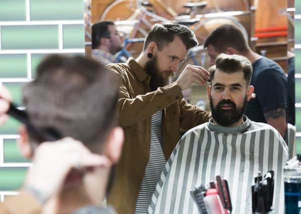 Trouser Town Bizarre Bazaar at the Birchcliffe Centre, Hebden Bridge. Mike Cuthbertson has his hair cut by barber Chris Brownless from North West Barber Co.