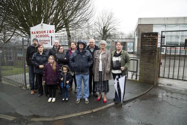 Complaints about Rawson School, Boothtown, changing it's times. From the left, Lee Power, Georgina Leech, Jenny Zaccardelli, eight, Roberto Zaccardelli, Emma Power, Anna-Maria Zaccardelli, four, Sophia Zaccardelli, Philip King, councillor Tim Swift, councillor Megan Swift and Leanne Sprint.