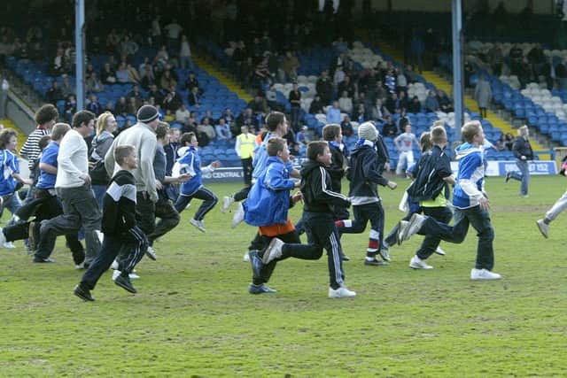 Town fans run onto the pitch after their team's 2-1 defeat to Stevenage in 2008.