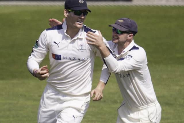 Yorkshire's Alex Lees is congratulated by Adam Lyth on taking a catch to dismiss Surrey's Kumar Sangakkara. Picture by Allan McKenzie/SWpix.com